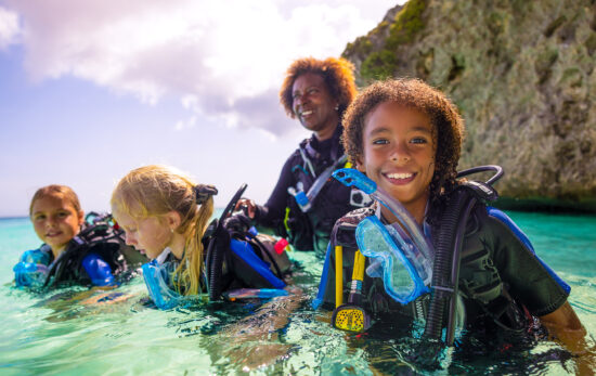 three young girls try scuba diving in Curacao with a PADI Instructor